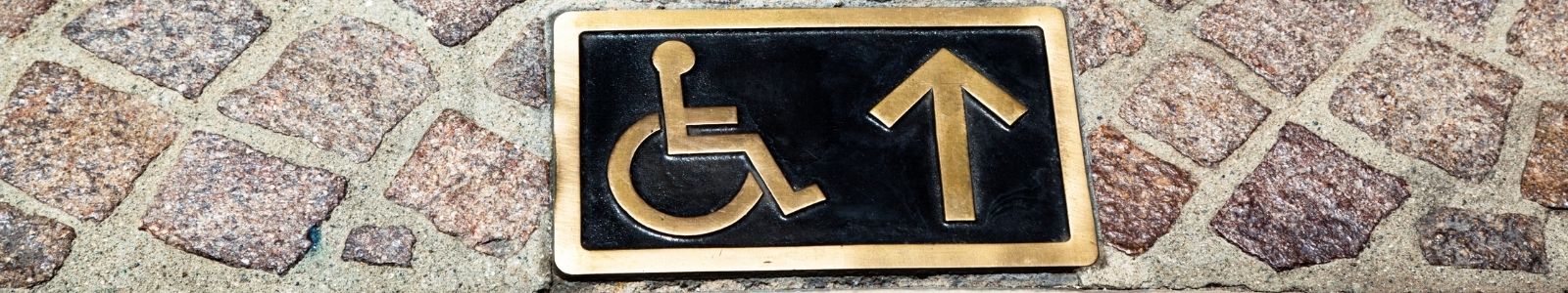 wheelchair sign on sidewalk