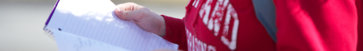 student holding notebook