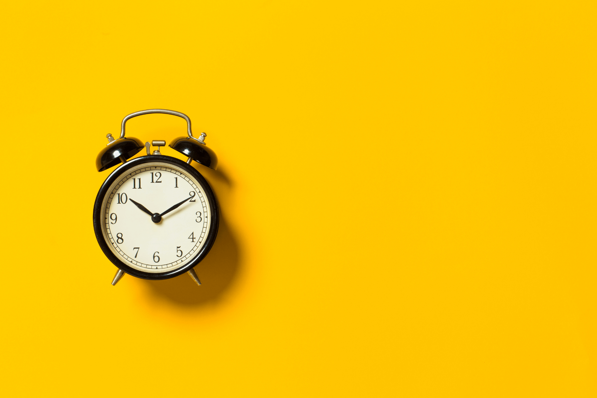 alarm clock on yellow background